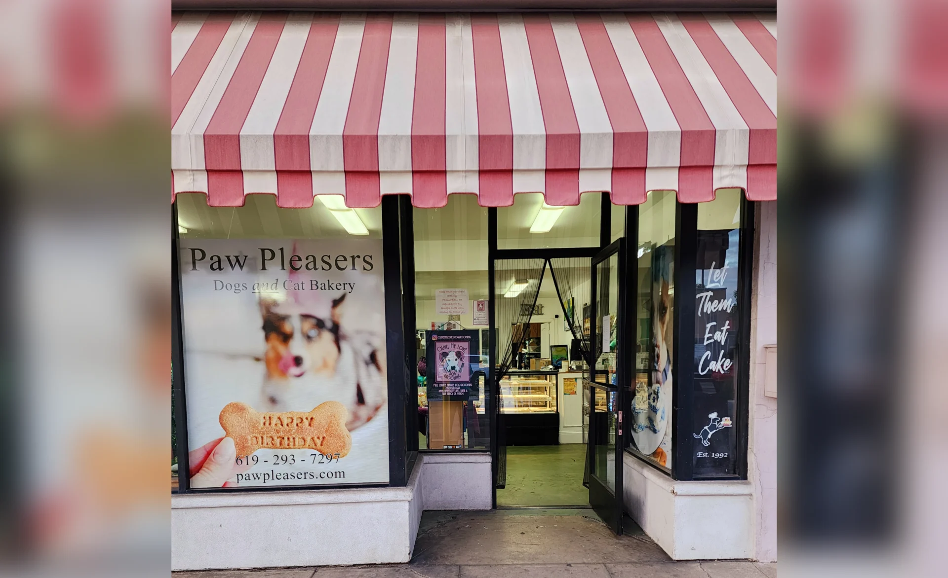 Pet bakery storefront with striped awning.