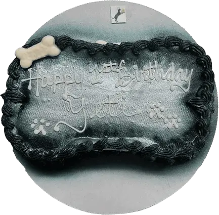 Dog bone cake with birthday message.