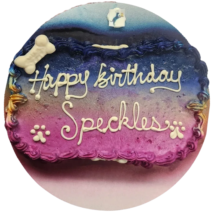 Colorful birthday cake for Speckles with pawprints.