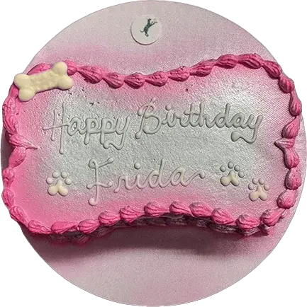 Dog-themed birthday cake with pink decoration.