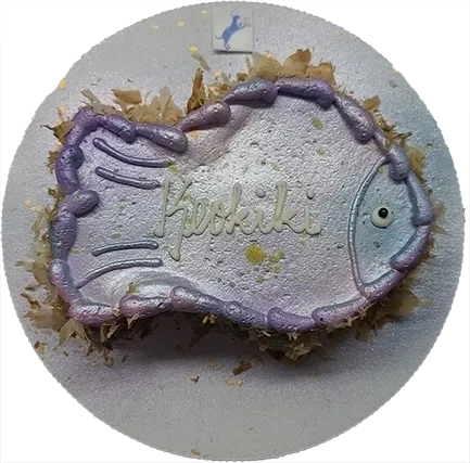 Fish-shaped cake with decorative icing.