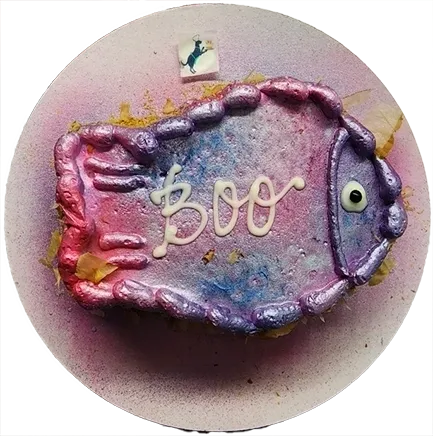 Colorful fish-shaped cake with "Boo" icing.