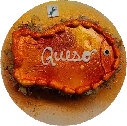 Fish-shaped cake with "Queso" icing decoration.