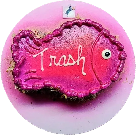 Pink fish-shaped cake with "Trash" text.
