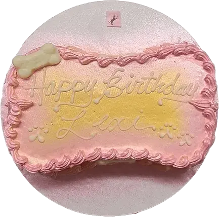 Pink birthday cake with bone decoration.