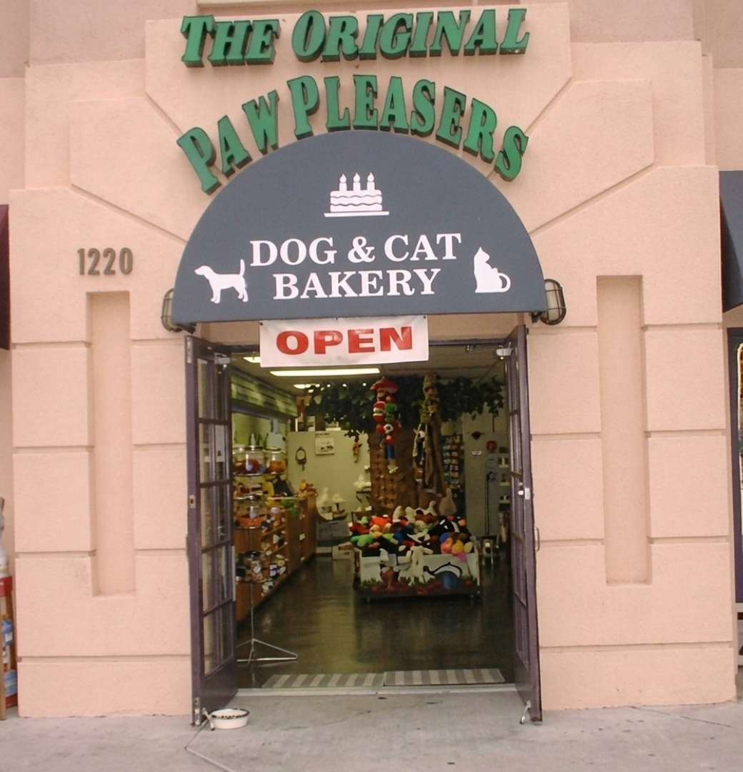 Dog and cat bakery storefront, open sign.