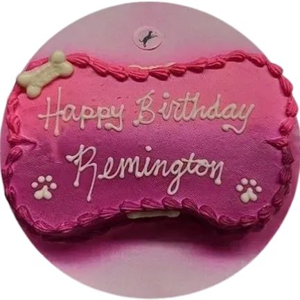 Pink dog birthday cake with bone decoration.