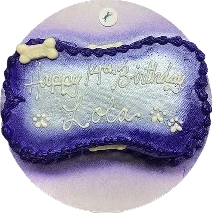 Purple dog bone cake with birthday message.