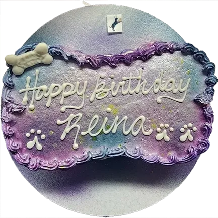 Purple birthday cake with dog bone decoration.
