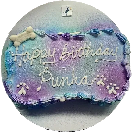 Colorful dog-themed birthday cake with paw prints.