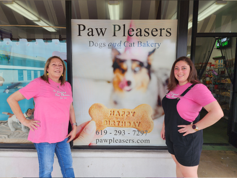 Two women outside a pet bakery.