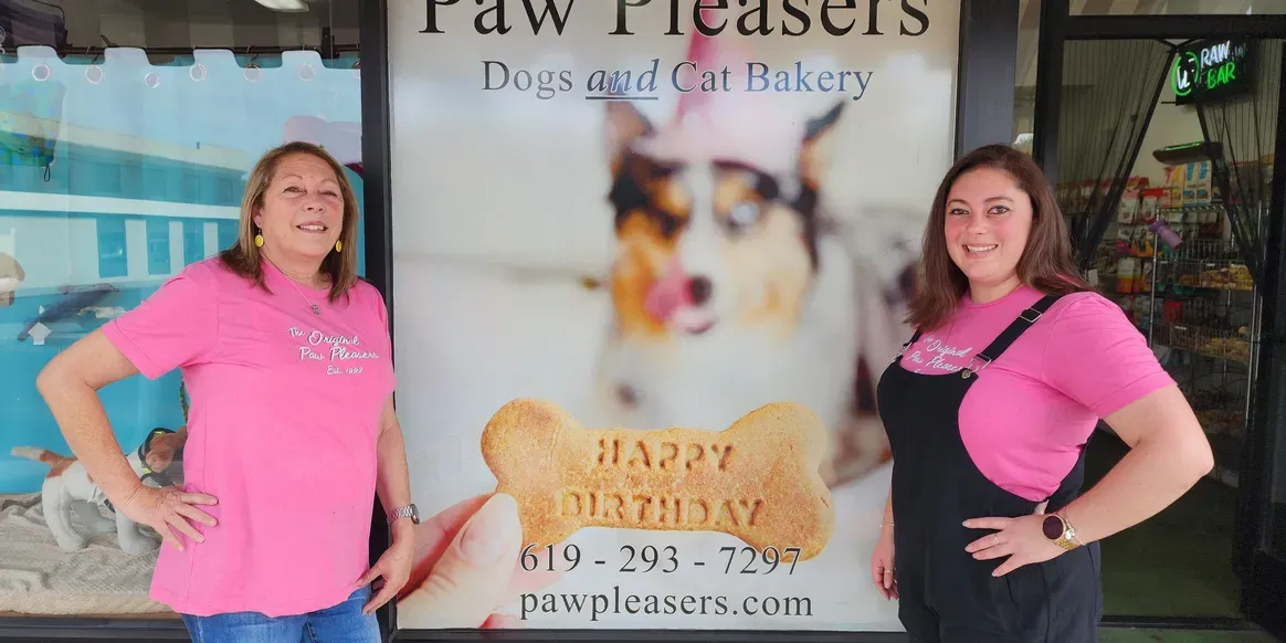 Women smiling outside Paw Pleasers bakery