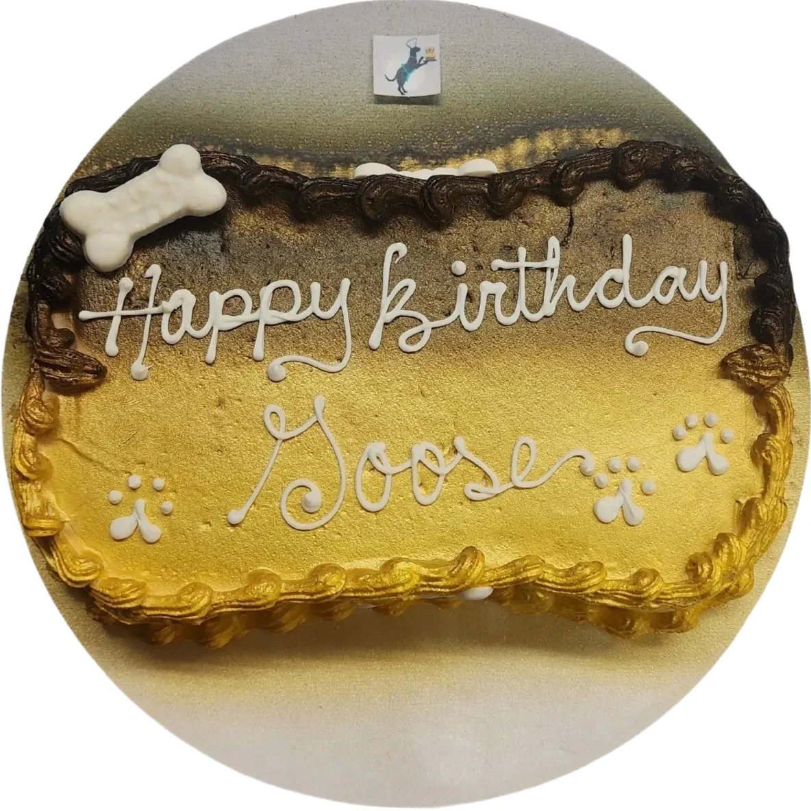 Dog birthday cake with paw prints design.