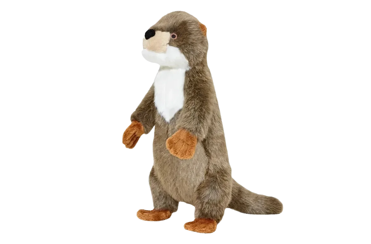 Stuffed otter toy on black background.