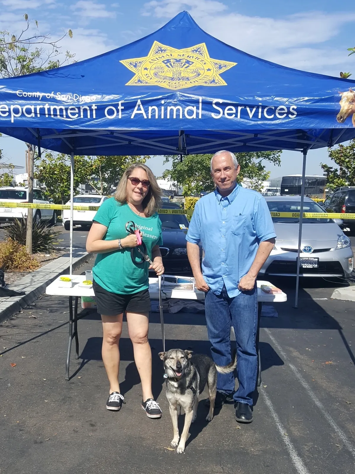 People with dog at animal services event.