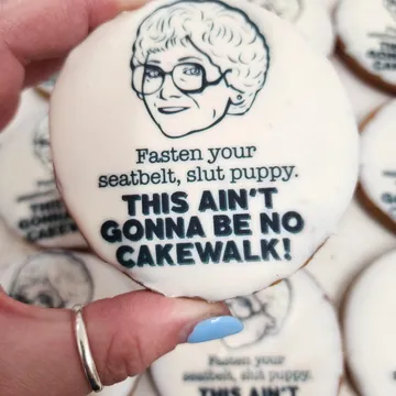 White cookie with illustration and bold text