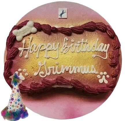 Dog-themed birthday cake with "Happy Birthday" text.