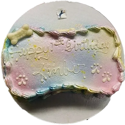 Pastel dog birthday cake with decorations.