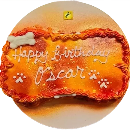 Dog-themed birthday cake with "Happy Birthday Oscar.
