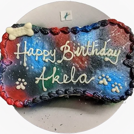 Colorful birthday cake with paw prints decoration.