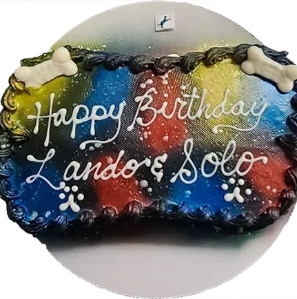 Colorful birthday cake with dog bone decorations.