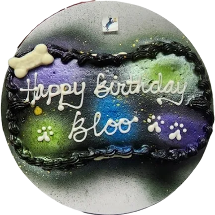 Colorful birthday cake with paw prints decoration.