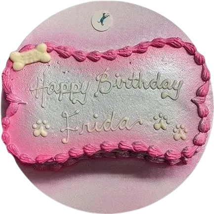 Pink dog birthday cake with paw decorations.