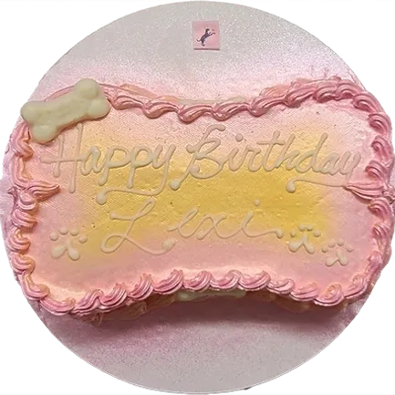 Pink and yellow birthday cake with frosting.