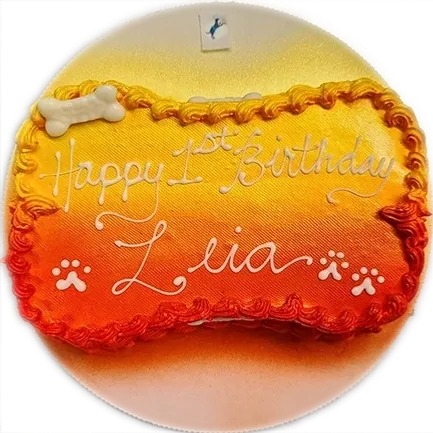 Dog birthday cake with bone and paw prints.