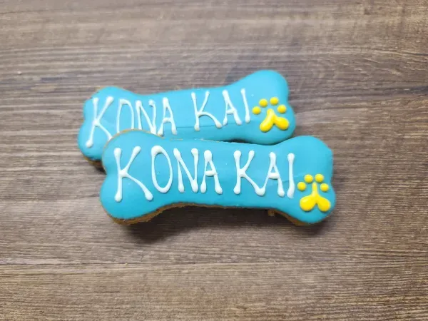 Custom bone-shaped dog biscuits on table