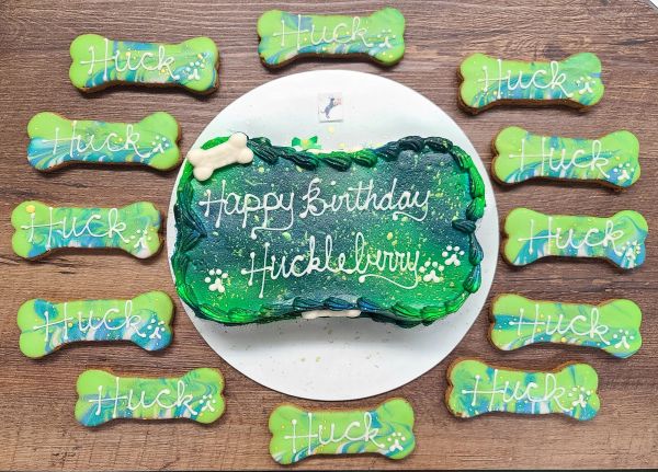 Dog-themed birthday cake with bone cookies