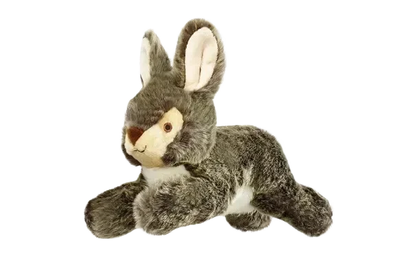Plush bunny toy on black background.