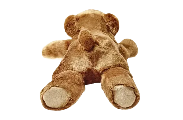 Brown teddy bear lying on black background.