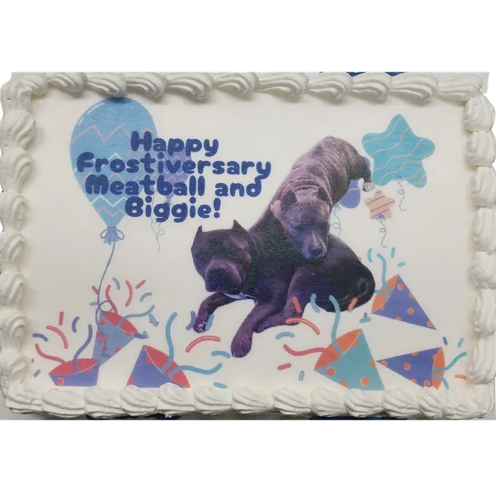 Decorative cake with dogs and festive design.