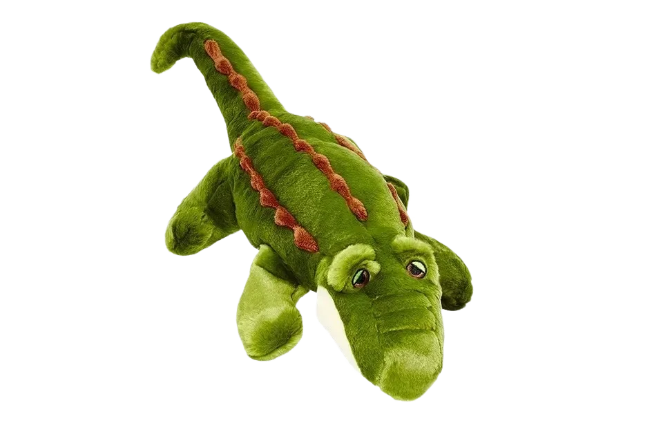 Green plush crocodile toy on black background.